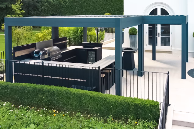Outdoor kitchen in Runnymede, Surrey with large u shaped outdoor kitchen under pergola on patio