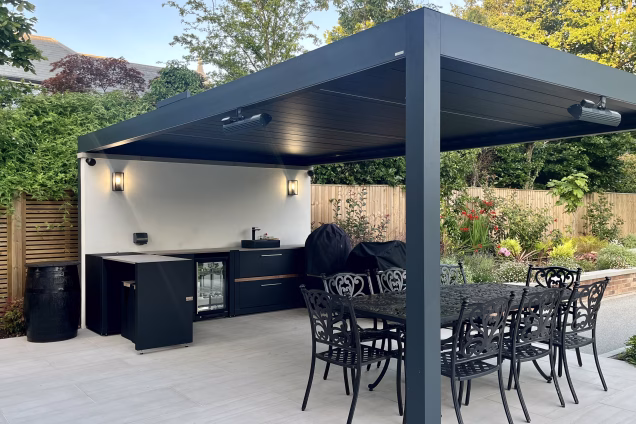 outdoor kitchen under pergola on patio with tarn sink, gusto charcoal bbq and storage cabinets