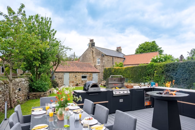 outdoor kitchen and dining area in garden