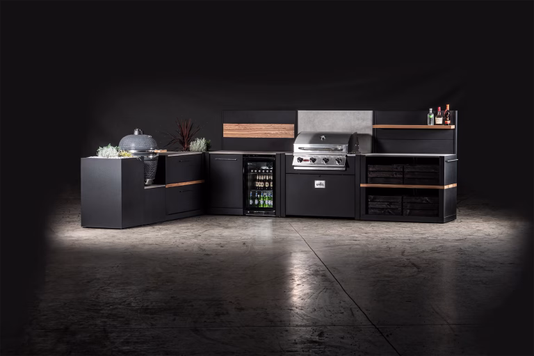 outdoor kitchen with bull gas grill and gusto charcoal bbq, storage units and drinks fridge in studio
