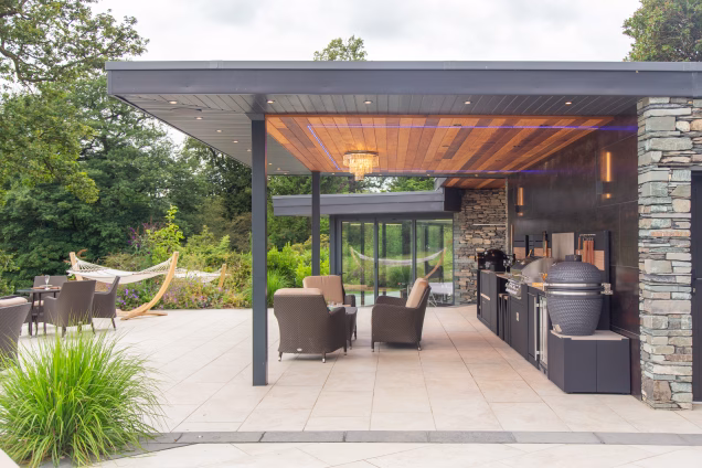 outdoor kitchen and bbqs under large built in covering
