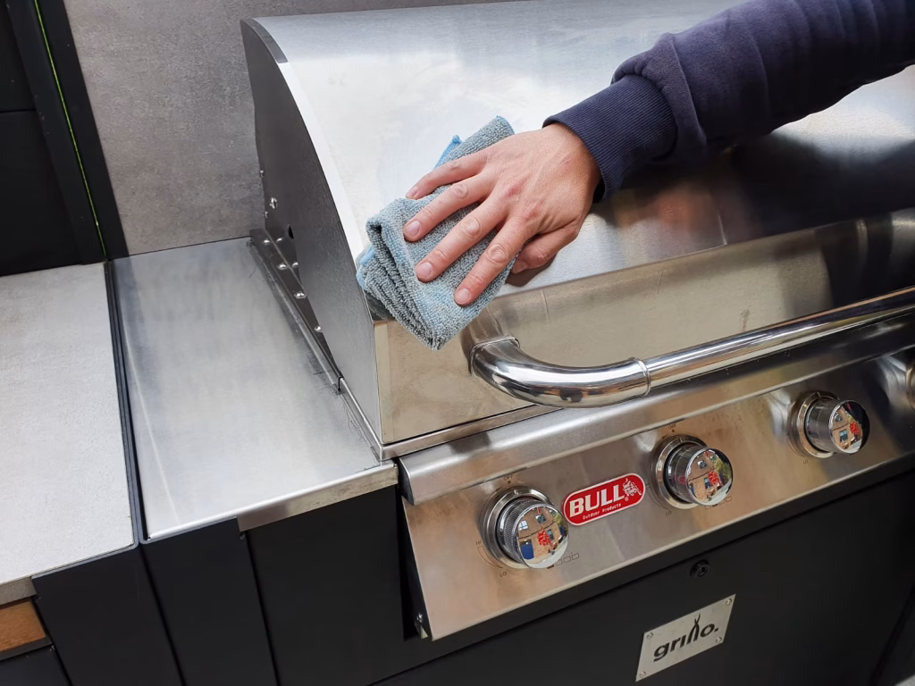 Bull Outlaw gas grill being polished with a lint-free cloth