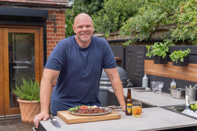 tom kerridge with fish he cooked on grillo outdoor kitchen