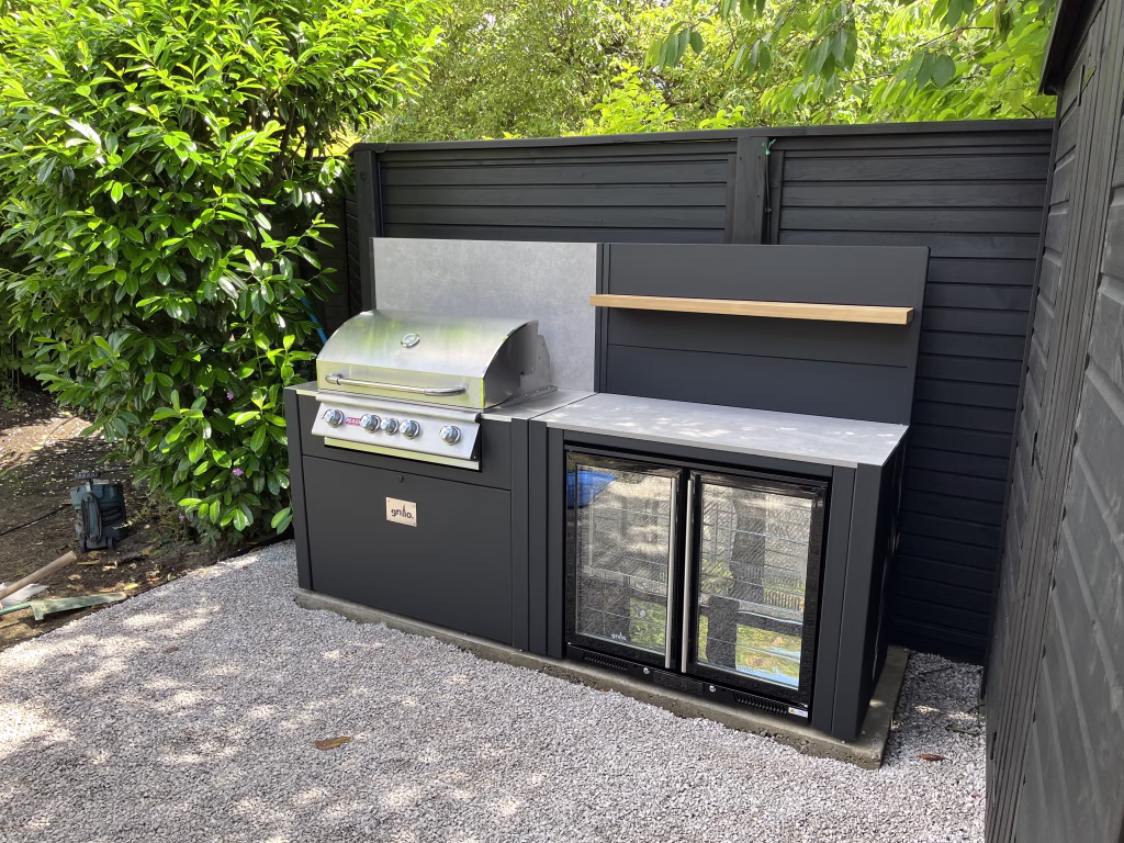 outdoor kitchen with gas grill station and double drinks fridge
