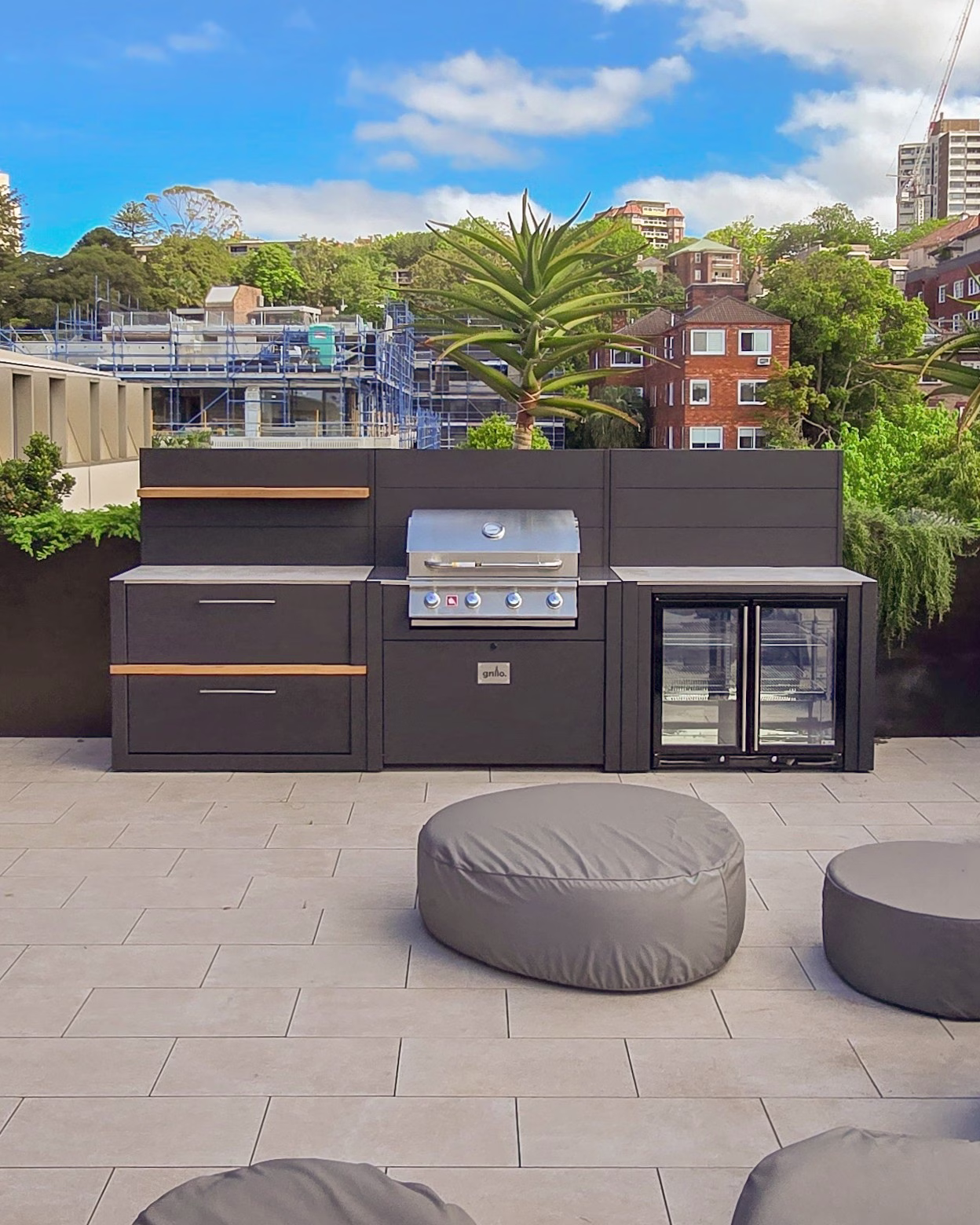 outdoor kitchen on paving with double drinks fridge, bull gas grill and storage cabinet