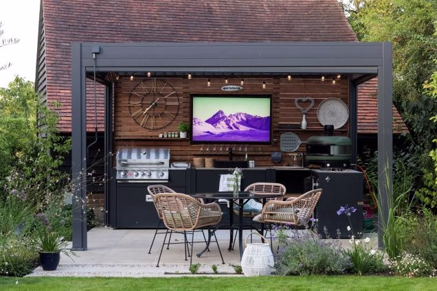 outdoor kitchen under pergola with gas grill station and gozney pizza oven