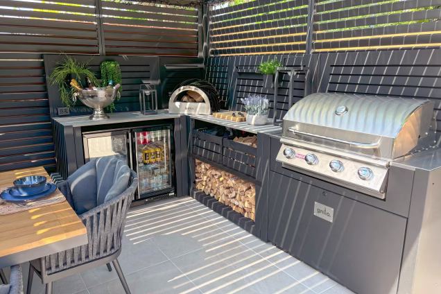 element outdoor kitchen with bull gas grill station, pizza oven, double fridge and storage unit