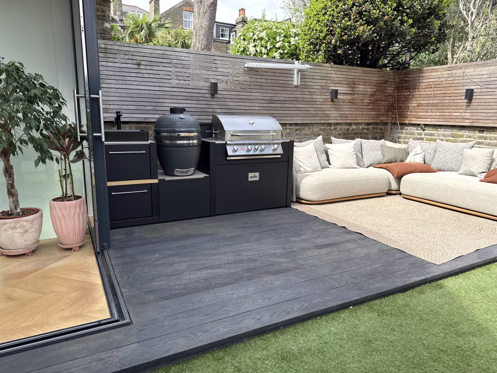 outdoor kitchen on decking next to seating area